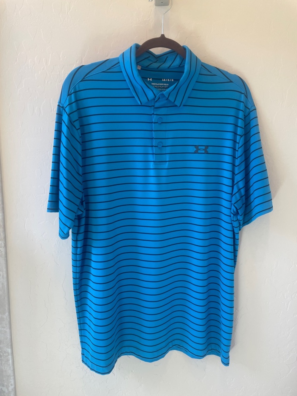 Size L Under Armour golf polo—mid blue with black stripes.  Charcoal logos.